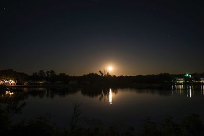 Scenic view of lake against sky at night