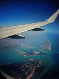 Aerial view of cityscape seen through airplane window