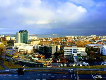 High angle view of buildings by sea against sky