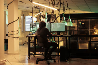 Rear view of woman sitting in cafe