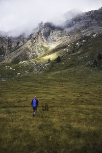 Man on field against mountain