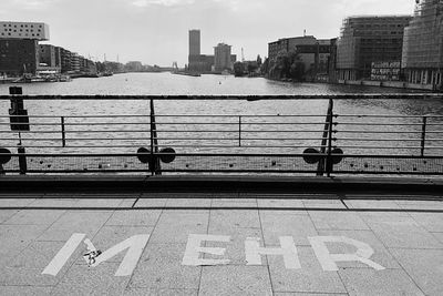 City street by river against sky