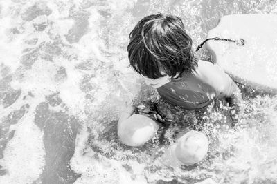 High angle view of girl playing in swimming pool