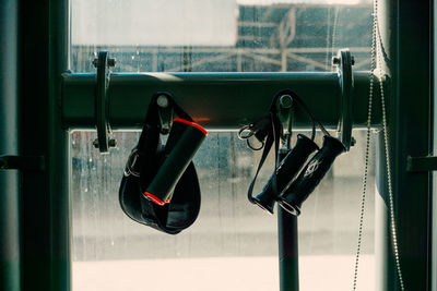 Close-up of electric lamp hanging on window