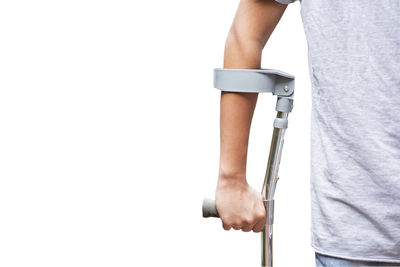 Rear view of man holding hands against white background