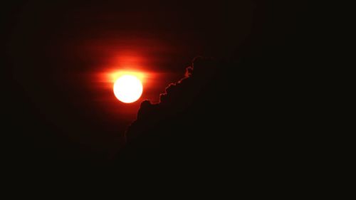 Low angle view of silhouette sun in sky