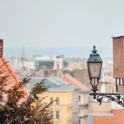 Street light by building against sky