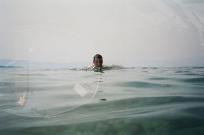 High angle view of woman swimming in sea