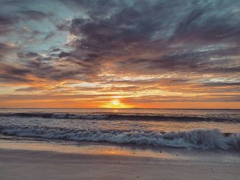 Scenic view of beach against sky during sunset