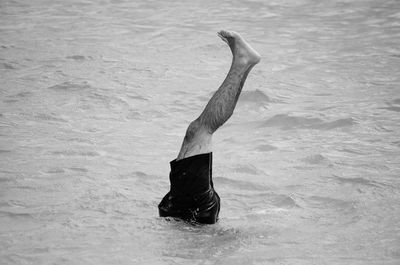 Low section of man diving in sea