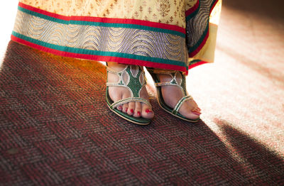 Low section of woman standing on carpet