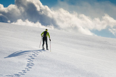 Full length of man skiing on snow covered mountain