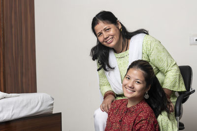 Portrait of young woman sitting at home