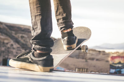 Low section of man skateboarding in park