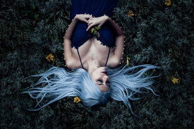 High angle view of woman lying on grass field