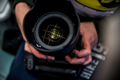 Midsection of man photographing with camera