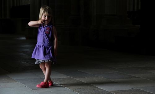 Girl standing in the dark
