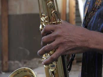 Cropped image of man holding trumpet