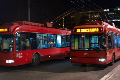 View of bus on street in city at night