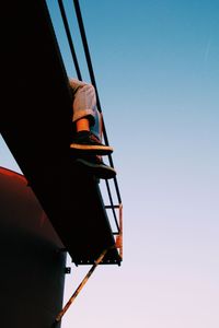 Low angle view of person against clear sky