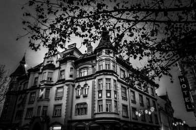 Low angle view of building and trees against sky