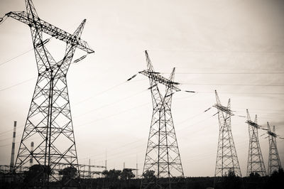 Low angle view of electricity pylon against sky