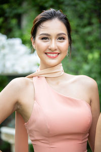 Portrait of smiling woman standing outdoors