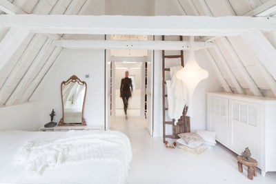 Man standing on bed in bedroom