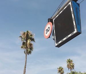 Low angle view of road sign against sky