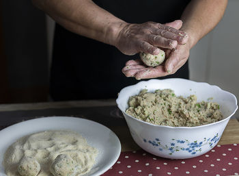 Midsection of man preparing food on table