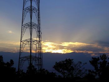 Low angle view of electricity pylon against sky