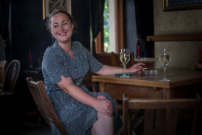 Smiling woman sitting at table