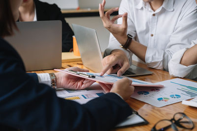 Midsection of business colleagues working at office