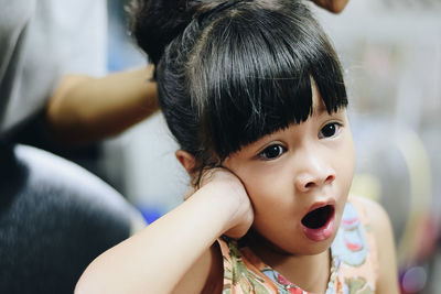 Girl yawning while sitting in beauty spa