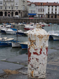 Boats moored at harbor in city