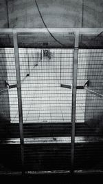 Chainlink fence seen through chainlink fence