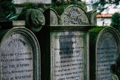 Close-up of text on stone at cemetery