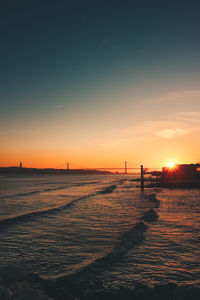 Scenic view of beach against sky during sunset