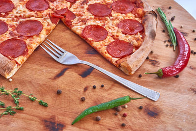 High angle view of pizza on cutting board