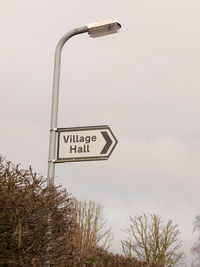 Low angle view of road sign against sky