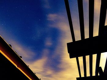 Low angle view of silhouette building against sky at dusk