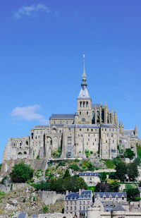 Low angle view of historical building against blue sky