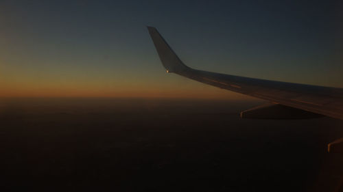 Airplane wing against clear sky