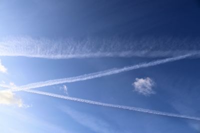 Low angle view of vapor trail against blue sky