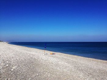 Scenic view of sea against blue sky