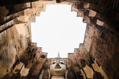 Low angle view of statues on wall of building