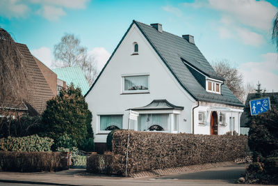 Houses by street against sky in city