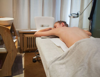 Midsection of man sitting on floor