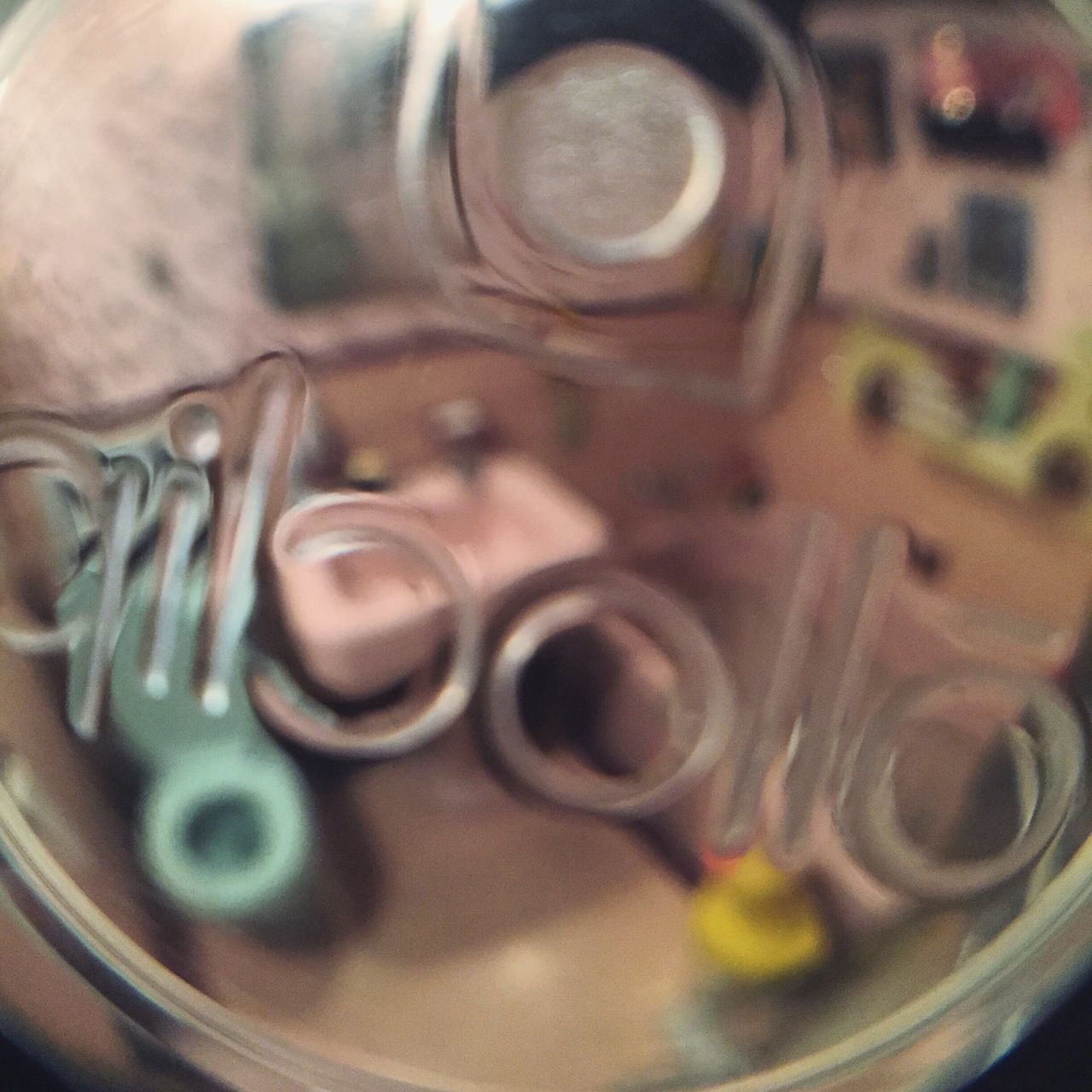 indoors, close-up, still life, selective focus, full frame, metal, table, focus on foreground, no people, backgrounds, glass - material, shiny, circle, metallic, large group of objects, detail, bottle, drink, high angle view, reflection