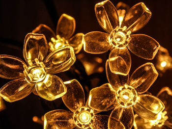 Close-up of illuminated lighting equipment against black background